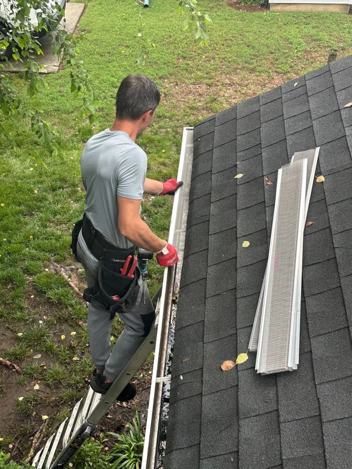Gutter Guards Charlotte installer fitting stainless micro-mesh gutter guards on a Charlotte home